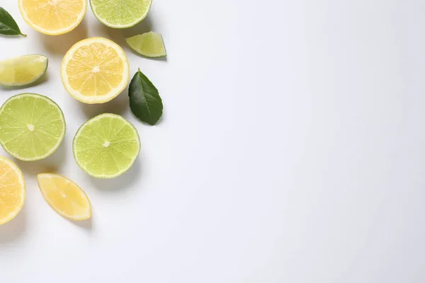 Fresh Ripe Lemons Limes Green Leaves White Background Top View — Stock Photo, Image