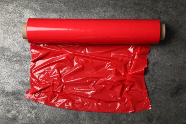 Gri taş zemin üzerinde kırmızı plastik gerinme rulo, üst görünüm