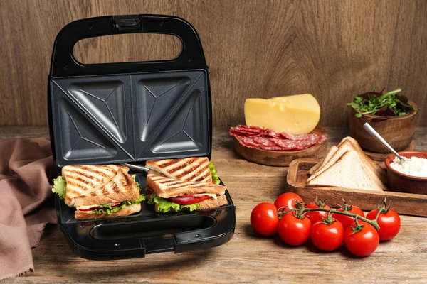 Moderne Grill Maker Met Sandwiches Verschillende Producten Houten Tafel — Stockfoto