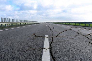 Depremden sonra asfalt yolda büyük çatlaklar oluştu.
