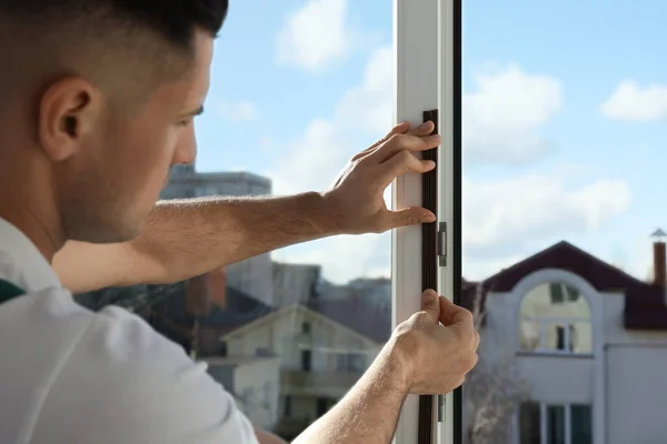 Man Sätter Gummi Dragband Fönstret Inomhus Fokusera Händerna — Stockfoto