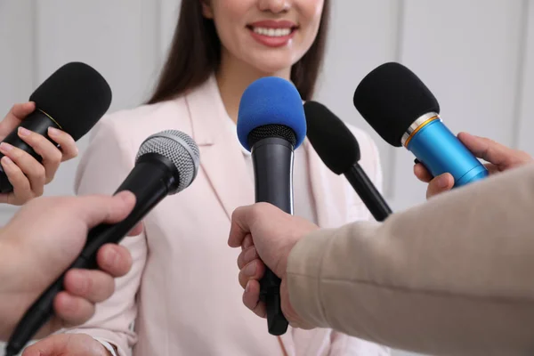 Happy business woman giving interview to journalists at official event, closeup