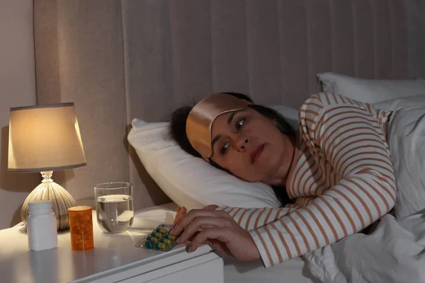 Ώριμη Γυναίκα Που Παίρνει Χάπια Από Κομοδίνο Στο Υπνοδωμάτιο Νύχτα — Φωτογραφία Αρχείου
