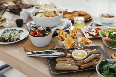 Farklı lezzetli yiyeceklerle dolu bir kahvaltı masası.