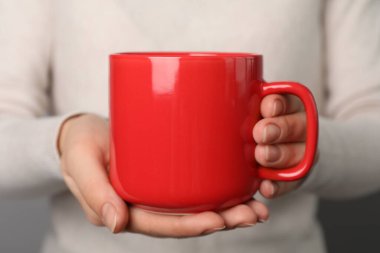 Woman holding mug of hot drink, closeup. Coffee Break clipart