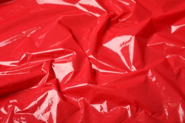 Arkaplan olarak kırmızı plastik germe paketi, yakın plan