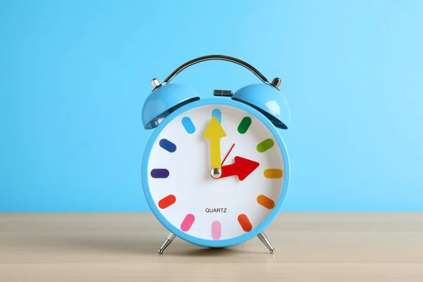 Reloj Despertador Sobre Mesa Madera Blanca Sobre Fondo Azul Claro —  Fotos de Stock