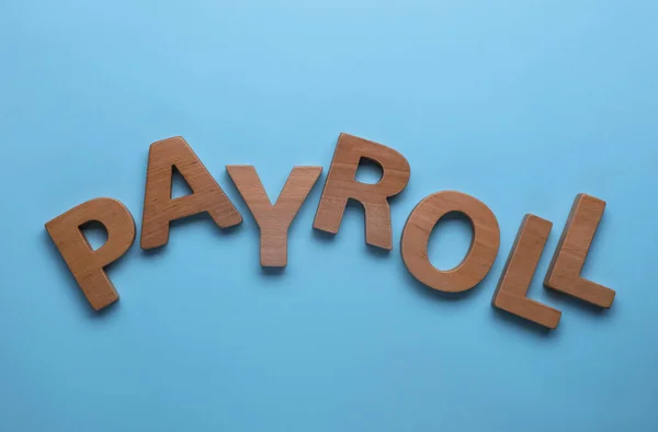 Word Payroll Gemaakt Met Houten Letters Lichtblauwe Achtergrond Plat Lay — Stockfoto