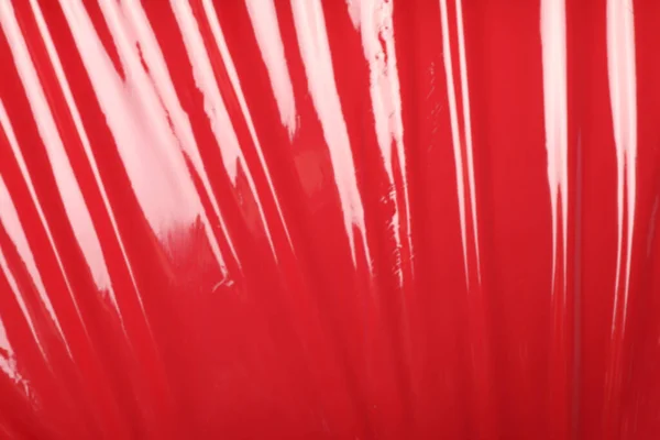 Röd Plast Streck Wrap Som Bakgrund Ovanifrån — Stockfoto