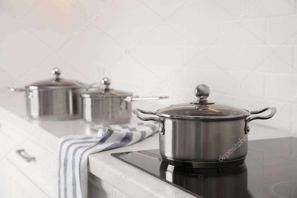New clean pot on cooktop in kitchen, space for text