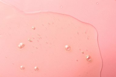 Pembe arka planda hidrofilik yağ örneği, üst görünüm