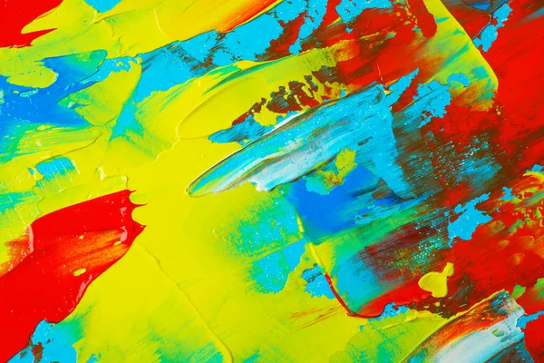 Arkaplan olarak karışık parlak boya içeren ressamın paletinin yakın görüntüsü