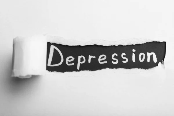 Słowo Depresja Czarnym Tle Widok Przez Dziurę Podartym Białym Papierze — Zdjęcie stockowe