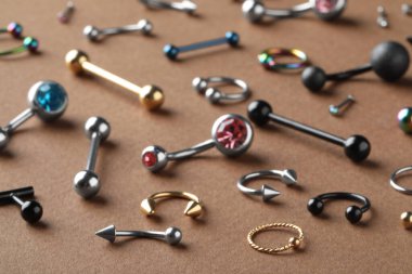 Kahverengi arka planda piercing için şık mücevherler