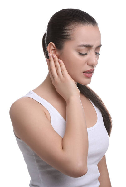 Young woman suffering from ear pain on white background