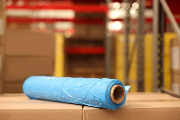 Roll of stretch wrap on boxes in warehouse