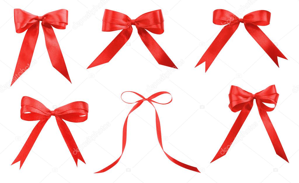 Set with beautiful red ribbons tied in bows on white background