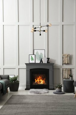 Elektrikli şömine ve dekor elementleriyle donatılmış şık bir oturma odası.