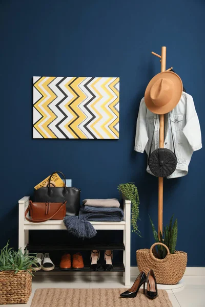 Hallway interior with stylish furniture, clothes and accessories