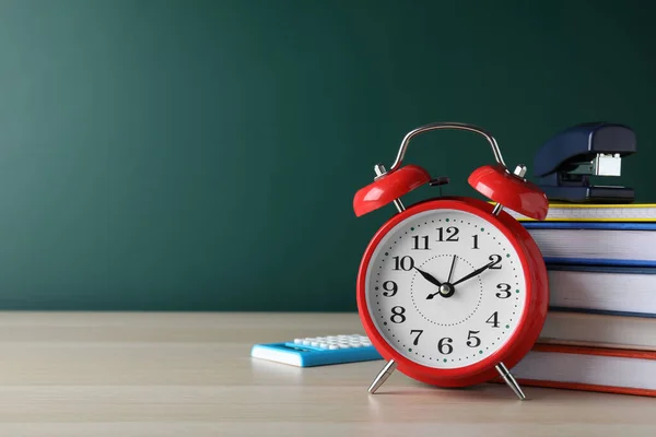 Alarm Clock Different Stationery Wooden Table Green Chalkboard Space Text — Stock Photo, Image