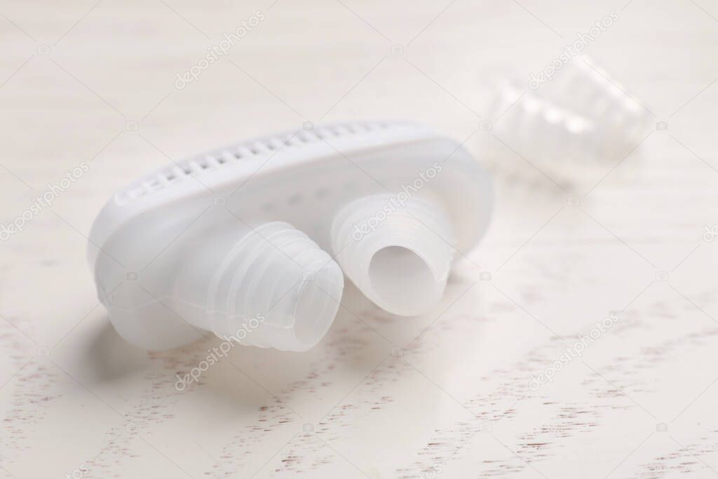 Anti-snoring device for nose on white wooden table, closeup