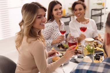 Bir grup insan kapalı bir masada brunch yapıyor.