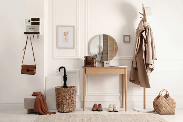 Modern hallway interior with stylish dressing table and key holder