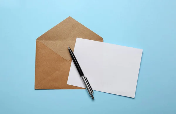 Brown Envelope Blank Letter Pen Light Blue Background Top View — Stock Photo, Image