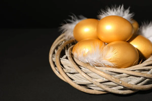 Siyah Arka Planda Tüyleri Olan Parlak Altın Yumurtalar Yakın Plan — Stok fotoğraf