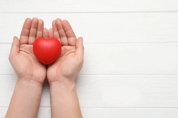 Man Holding Red Decorative Heart White Wooden Background Top View — Stock Photo, Image