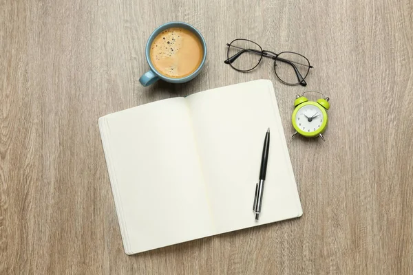 Open Notebook Glasses Alarm Clock Pen Cup Coffee Wooden Table — Stock Photo, Image