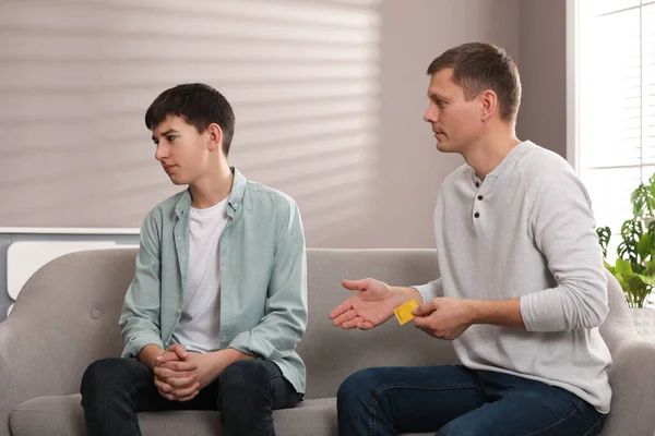 Father Talking His Teenage Son Contraception Home Sex Education Concept — стоковое фото
