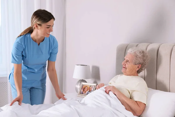 Young Caregiver Assisting Senior Woman Bedroom Home Health Care Service — 스톡 사진