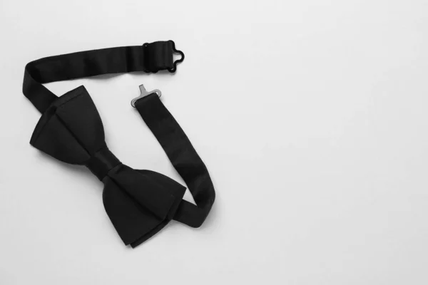 Stylish Black Bow Tie White Background Top View Space Text — Fotografia de Stock