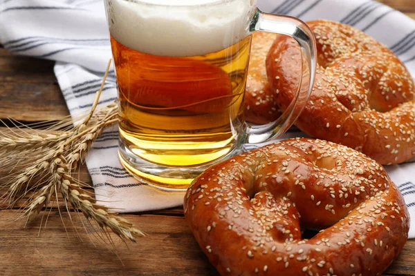Tasty Pretzels Glass Beer Wheat Spikes Wooden Table Closeup — Stock Photo, Image