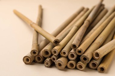 Bej arka planda kuru bambu çubukları, yakın plan.
