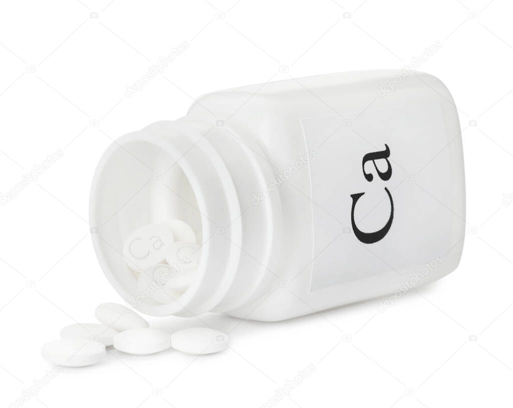 Overturned bottle of calcium supplement pills on white background