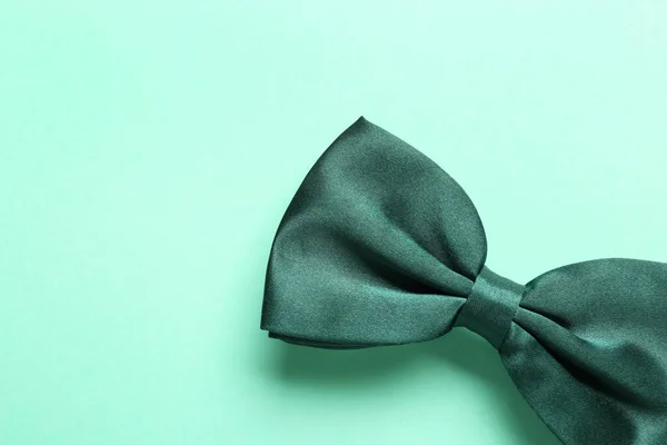 Stylish Satin Bow Tie Light Green Background Top View Space — Stockfoto