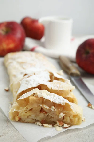 Delicious Apple Strudel Almonds Powdered Sugar Light Grey Table Closeup — Stock Fotó