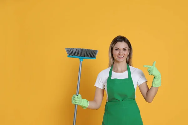 Young Woman Broom Orange Background Space Text — Fotografia de Stock