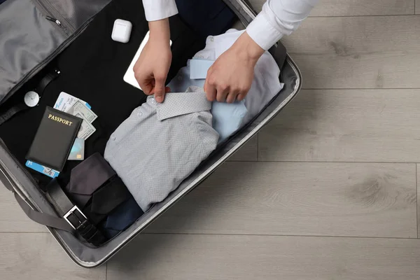 Man Packing Suitcase Wooden Floor Top View Space Text Business — 스톡 사진