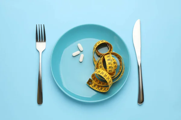 Plate Weight Loss Pills Measuring Tape Cutlery Light Blue Background — Fotografia de Stock