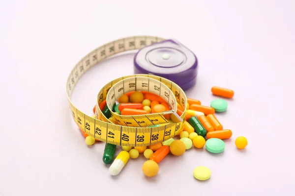 Many Different Weight Loss Pills Measuring Tape Violet Background — Fotografia de Stock