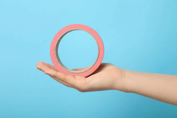 Woman Holding Pink Adhesive Tape Light Blue Background Closeup — Fotografia de Stock