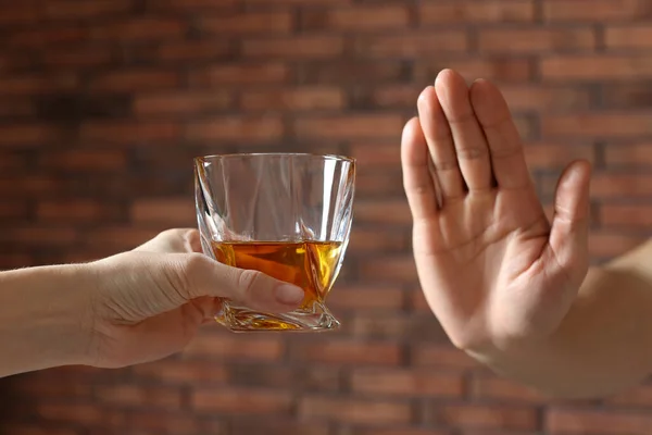 Man Refusing Drink Whiskey Red Brick Wall Closeup Alcohol Addiction — Foto Stock