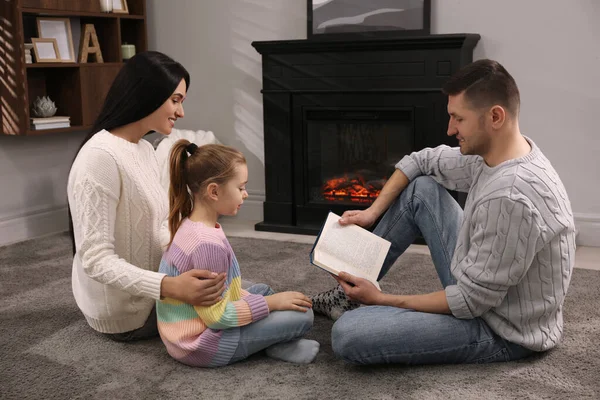 Šťastná Rodina Čtení Kniha Společně Podlaze Krbu Doma — Stock fotografie