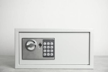 Beyaz arka planda elektronik kilidi olan çelik kasa