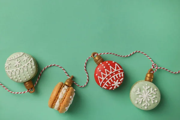 Beautifully Decorated Christmas Macarons Rope Turquoise Background Flat Lay Space — Stock Photo, Image