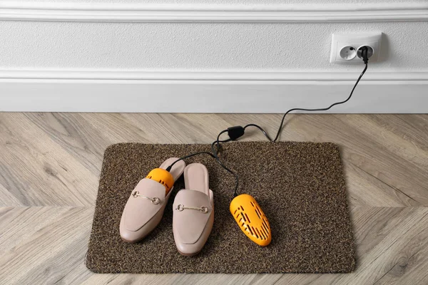 Pair Stylish Shoes Modern Electric Footwear Dryer Door Mat Indoors — Stock Photo, Image