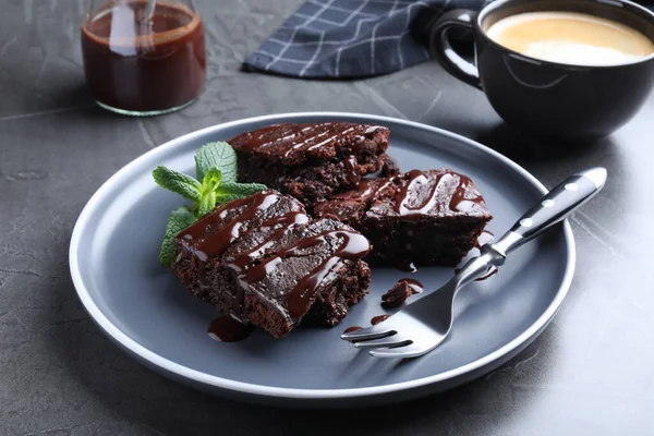 Delicious Chocolate Brownies Sweet Syrup Mint Served Grey Table — стоковое фото